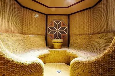 a tiled room with a toilet in the middle at STRIM Apartment 406 Stream Resort, Pamporovo in Pamporovo