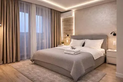 a bedroom with a large bed and a large window at Delux 1 - Plovdiv Луксозен апартамент с паркинг in Plovdiv