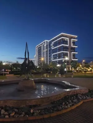 a building with a statue in front of a fountain at Delux 1 - Plovdiv Луксозен апартамент с паркинг in Plovdiv