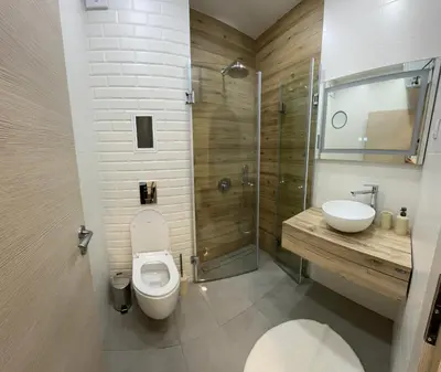 a bathroom with a toilet and a sink and a shower at Delux 1 - Plovdiv Луксозен апартамент с паркинг in Plovdiv