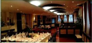 a large dining room with tables with white tablesearcher at FLORA Apartment Hotel STUDIO 411 in Borovets