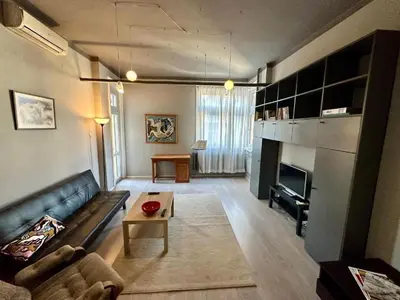a living room with a couch and a table at Downtown Serenity Apartment in Sofia