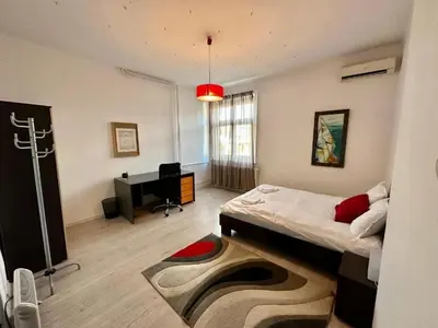 a room with a bed and a piano in it at Downtown Serenity Apartment in Sofia