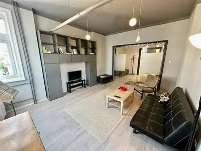 a living room with a couch and a table at Downtown Serenity Apartment in Sofia