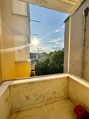 an empty room with a window with a view at Downtown Serenity Apartment in Sofia