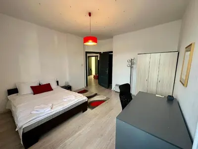 a bedroom with a bed and a desk in it at Downtown Serenity Apartment in Sofia