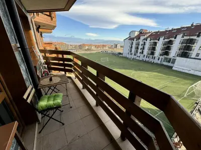 a balcony with a view of a soccer field at Elegant Apartment Ski Access Premium Spa in Bansko