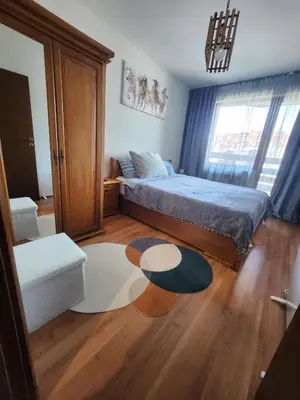 a bedroom with a bed and a coffee table at Elegant Apartment Ski Access Premium Spa in Bansko