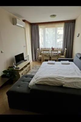 a bedroom with a bed and a table with a laptop at Pirin Golf Hotel & Spa in Razlog