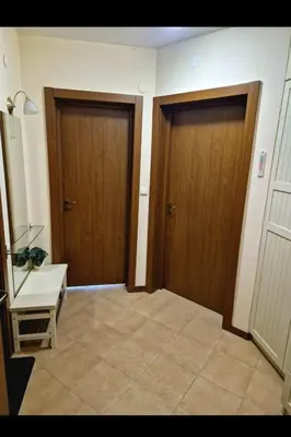 two wooden doors in a room with a tiled floor at Pirin Golf Hotel & Spa in Razlog