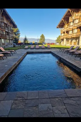 a pool of water in front of a building at Pirin Golf Hotel & Spa in Razlog