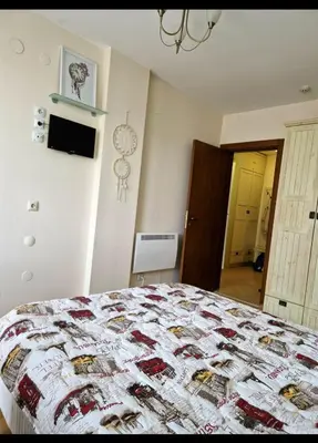 a bedroom with a bed with a quilt on it at Pirin Golf Hotel & Spa in Razlog