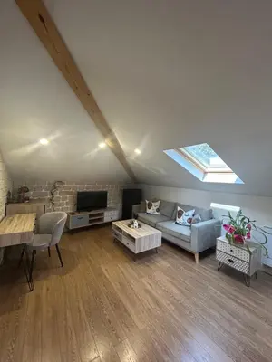 a living room with a couch and a table at Lambrina Boutique rooms in Plovdiv