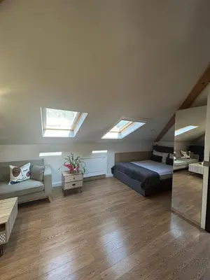 a room with a bed and a couch and skylights at Lambrina Boutique rooms in Plovdiv