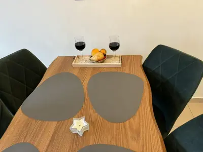 a table with two glasses of wine and a plate of fruit at Exclusive Ski and Spa Paradise Stylish Apartment in Bansko