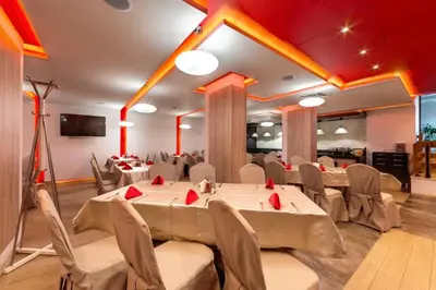 a banquet hall with tables and chairs in a room at Exclusive Ski and Spa Paradise Stylish Apartment in Bansko
