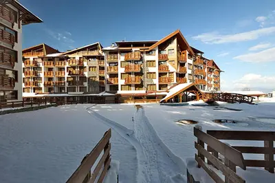 a large building in the snow with a rink at Exclusive Ski and Spa Paradise Stylish Apartment in Bansko