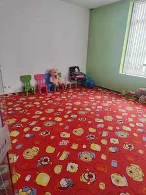 a room with a red carpet witheddy bears on the floor at Aspen Resort Studio I306 in Razlog