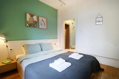 a bedroom with a bed with two towels on it at Classy Residential 1BDRM Flat With View and Elevator in Sofia