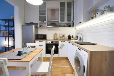 a kitchen with a table and a washing machine at Classy Residential 1BDRM Flat With View and Elevator in Sofia