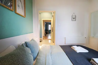 a bedroom with a bed and a green wall at Classy Residential 1BDRM Flat With View and Elevator in Sofia