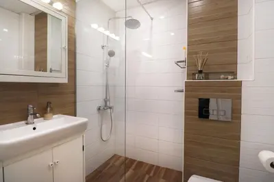 a bathroom with a shower and a sink and a toilet at Classy Residential 1BDRM Flat With View and Elevator in Sofia