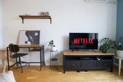 a living room with a television on a tv stand at Classy Residential 1BDRM Flat With View and Elevator in Sofia
