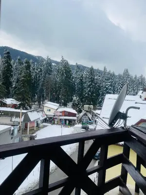 a view from a balcony of a town with a snowboard at Snow Forest in Borovets
