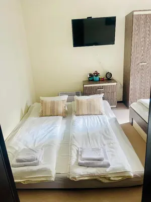 a bedroom with a large bed with two towels on it at Snow Forest in Borovets