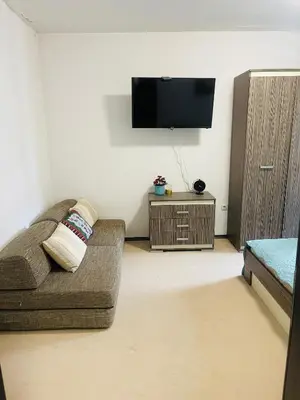 a living room with a couch and a flat screen tv at Snow Forest in Borovets