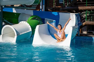 a woman on a water slide in the water at SPA Hotel Elbrus in Velingrad
