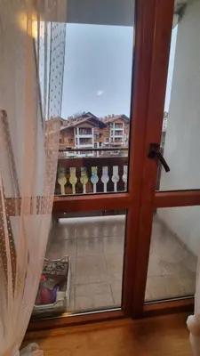 a view of a balcony through a glass door at Apartment Wintermärchen Bansko in Bansko