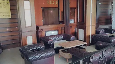 a waiting room with leather chairs and a table at Apartment Wintermärchen Bansko in Bansko