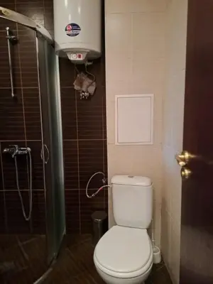 a small bathroom with a toilet and a shower at Apartment Wintermärchen Bansko in Bansko