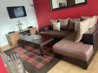a living room with a couch and a table at 27 Monastery in Bansko