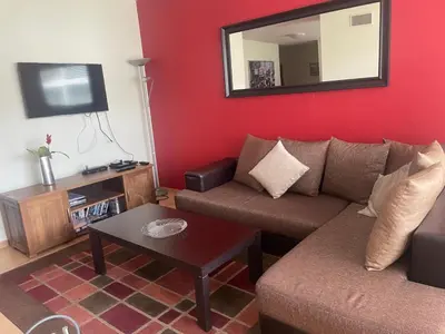 a living room with a couch and a mirror at 27 Monastery in Bansko