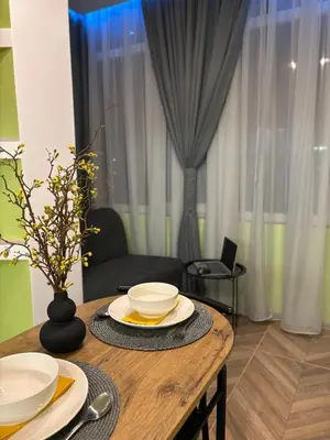 a wooden table with plates and bowls on top of it at Inspiration Nook in Sofia