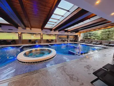 a large indoor swimming pool in a building at Slopes View Private Apartment - Luxury SPA in the 4-Star St Ivan Rilski Complex in Bansko