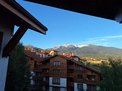 a view of a building with mountains in the background at Slopes View Private Apartment - Luxury SPA in the 4-Star St Ivan Rilski Complex in Bansko