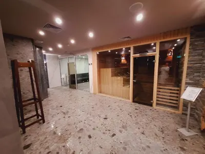 a room with a wall of glass doors and a building at Slopes View Private Apartment - Luxury SPA in the 4-Star St Ivan Rilski Complex in Bansko