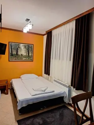 a bedroom with a bed and a window at Slopes View Private Apartment - Luxury SPA in the 4-Star St Ivan Rilski Complex in Bansko