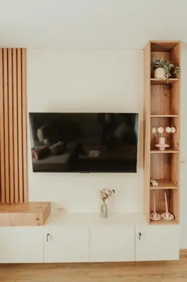 a television on a white wall in a living room at Apartment Aria 2 in Velingrad