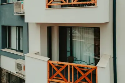a balcony with a table and chairs on a building at Apartment Aria 2 in Velingrad
