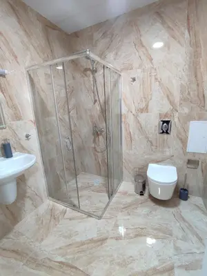a bathroom with a shower and a toilet at Pana Green Residence in Panagyurishte
