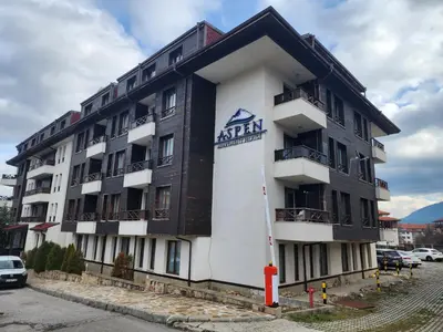 a building with aania sign on the side of it at Pirin View Apartment in Bansko