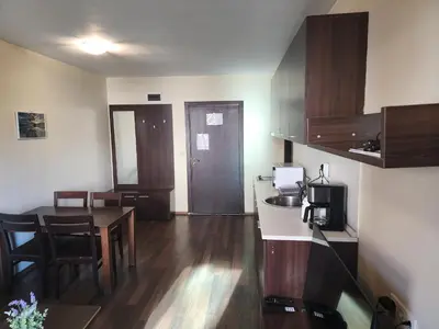 a room with a kitchen and a dining room at Pirin View Apartment in Bansko