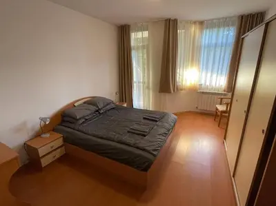 a bedroom with a bed and a dresser in it at FLORA Apartment Hotel 412 in Borovets