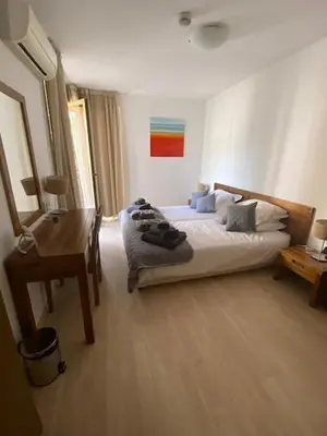 a bedroom with a bed and a desk and a bed sidx sidx sidx at St John Hill Alexander Services Apartments in Bansko