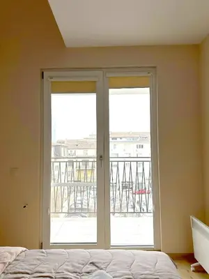 a bedroom with two sliding glass doors and a balcony at Old City Views - Luxury 2BDR Apt & Free Parking in Sofia
