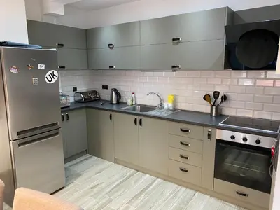 a kitchen with a stainless steel refrigerator and a sink at Elegant 3 Alexander Services Apartments luxury four bedroom penthouse in Bansko